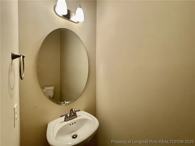 an empty room with wooden floor fireplace and windows