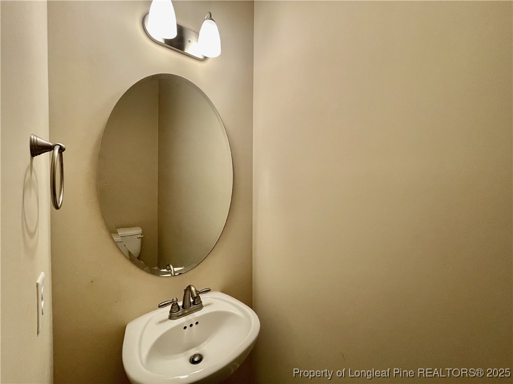608 Stonebriar Avenue Raeford, NC 28376 - Photo 18 of 29 a bathroom with a sink and a mirror