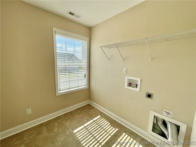 a view of a room with rack on the wall and a window