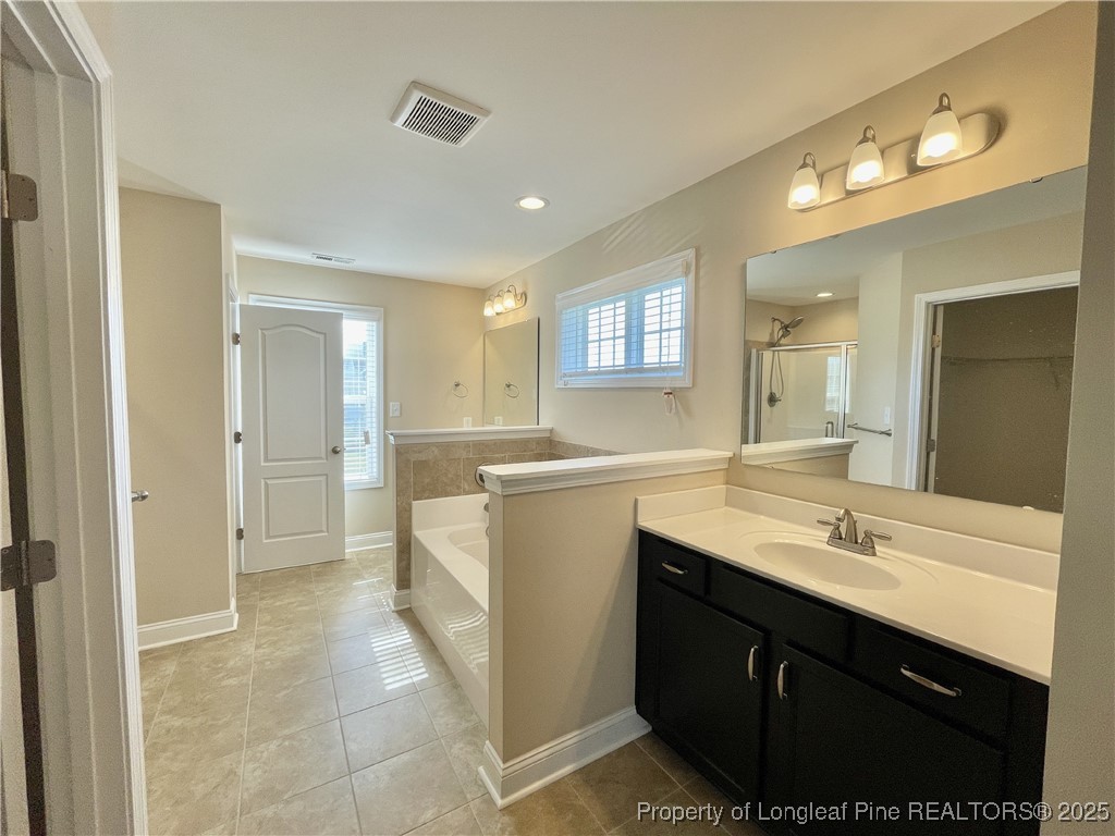608 Stonebriar Avenue Raeford, NC 28376 - Photo 6 of 29 a spacious bathroom with a sink and a mirror