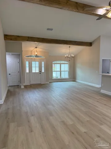a kitchen with a sink stove and wooden floor
