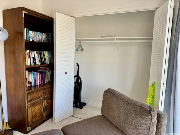 a living room with couch and a book shelf