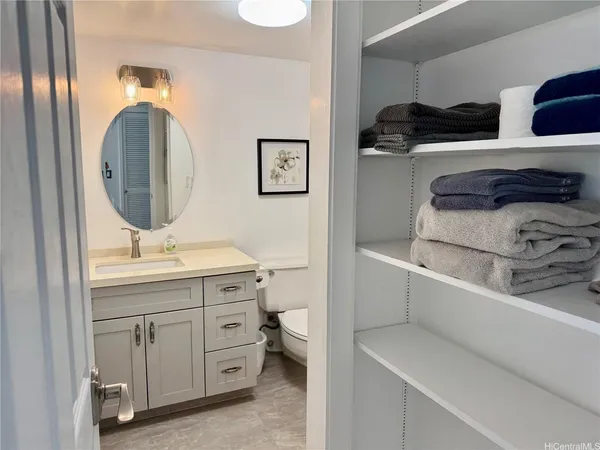 a bathroom with a toilet a sink and a mirror