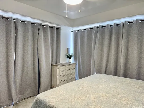 a bedroom with a bed and a mirror