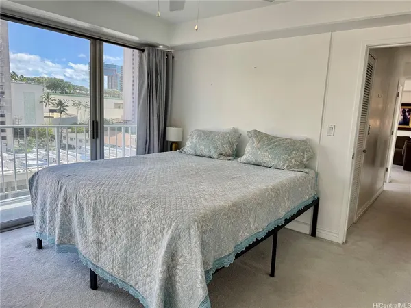 a bedroom with a bed and a large window