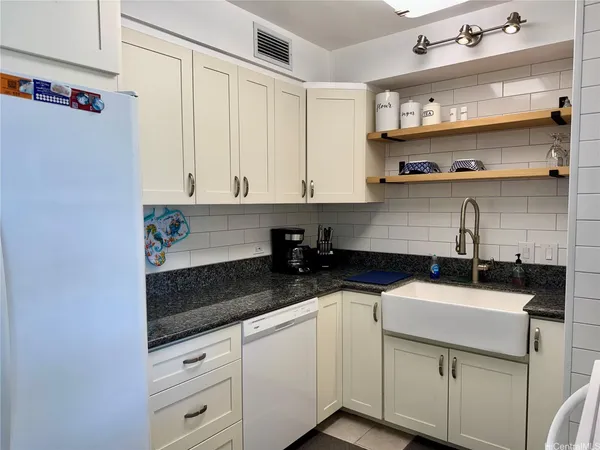 a kitchen with stainless steel appliances granite countertop a sink and a stove