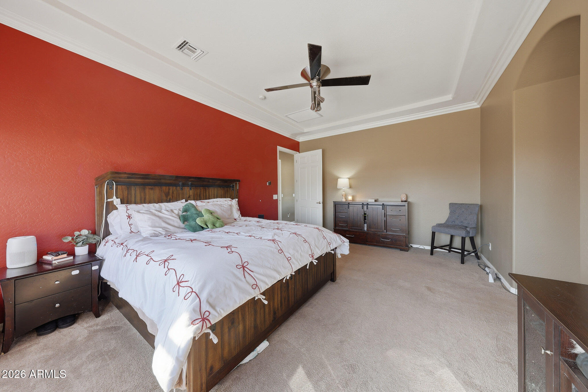 23024 West Sierra Ridge Way Wittmann, AZ 85361 - Photo 42 of 99 a spacious bedroom with a bed and a chandelier