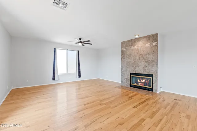 a view of empty room with a fireplace