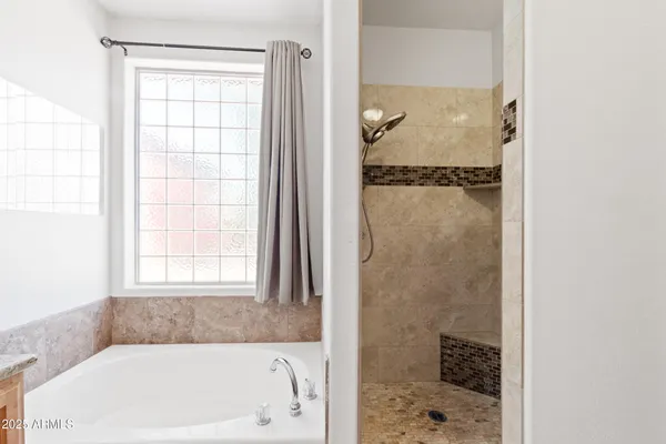 a bathroom with a tub and a shower