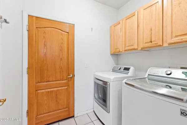 a view of storage and utility room with washer and dryer