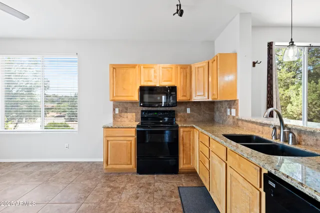 a kitchen with granite countertop a stove and a sink