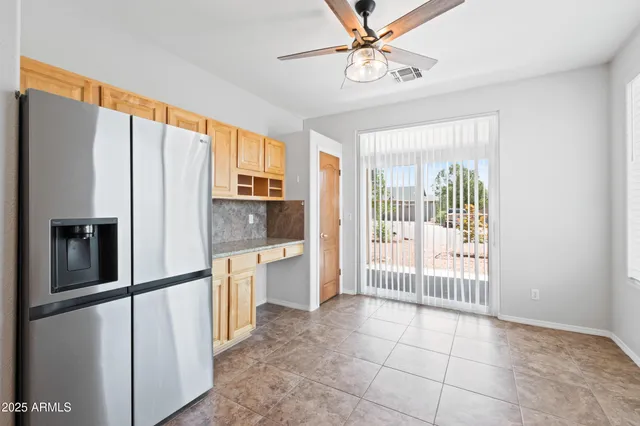 a kitchen with stainless steel appliances granite countertop a refrigerator a stove a sink and a refrigerator with wooden floor