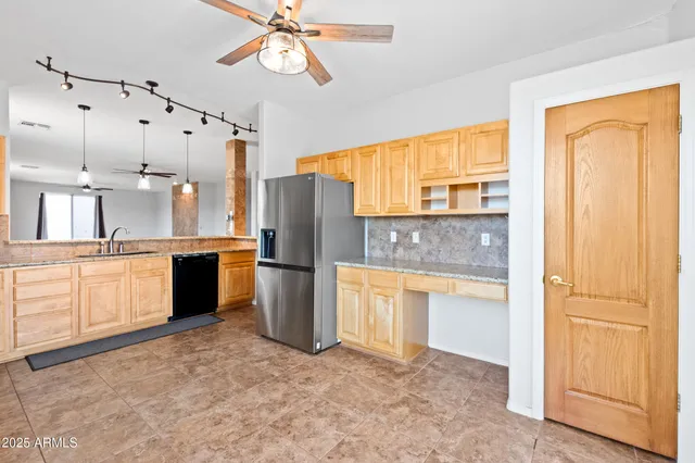 a kitchen with stainless steel appliances a refrigerator and cabinets