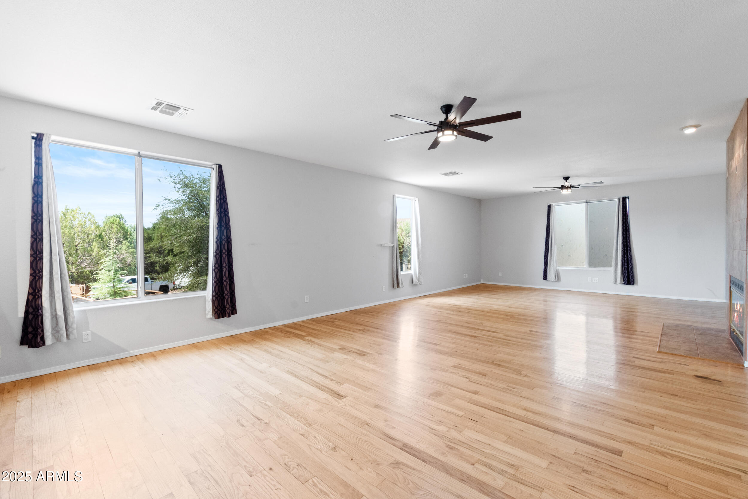 102 South Whiting Drive Payson, AZ 85541 - Photo 10 of 30 a view of an empty room with window and wooden floor