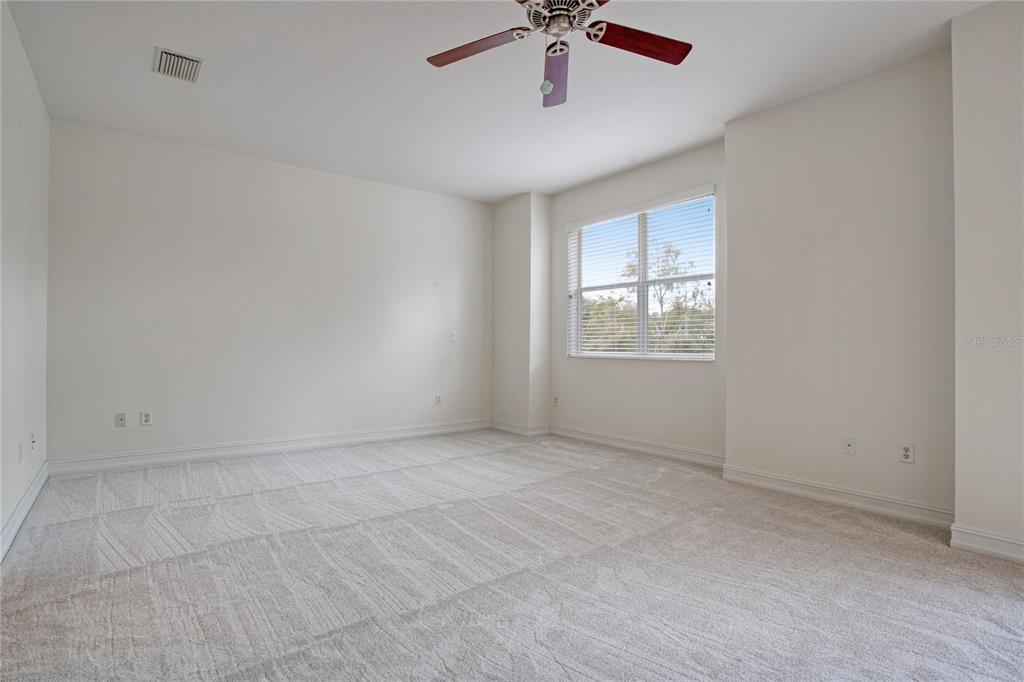 1344 Ribolla Drive Palm Harbor, FL 34683 - Photo 13 of 26 an empty room with a window and a fan