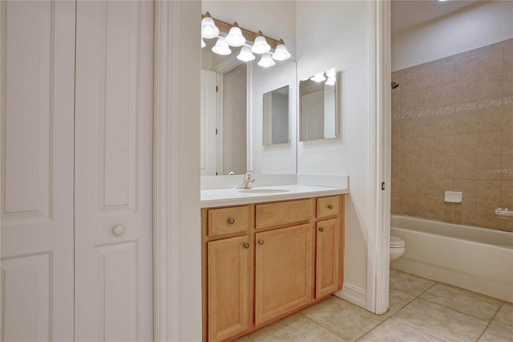 1344 Ribolla Drive Palm Harbor, FL 34683 - Photo 15 of 26 a bathroom with a sink a mirror and a bathtub