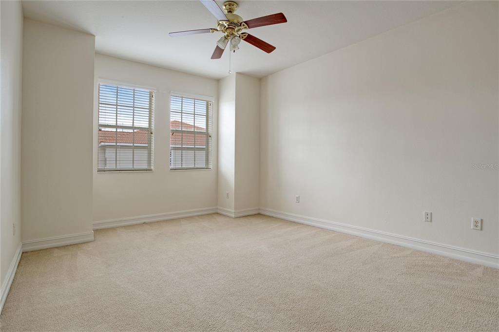 1344 Ribolla Drive Palm Harbor, FL 34683 - Photo 18 of 26 an empty room with windows and fan
