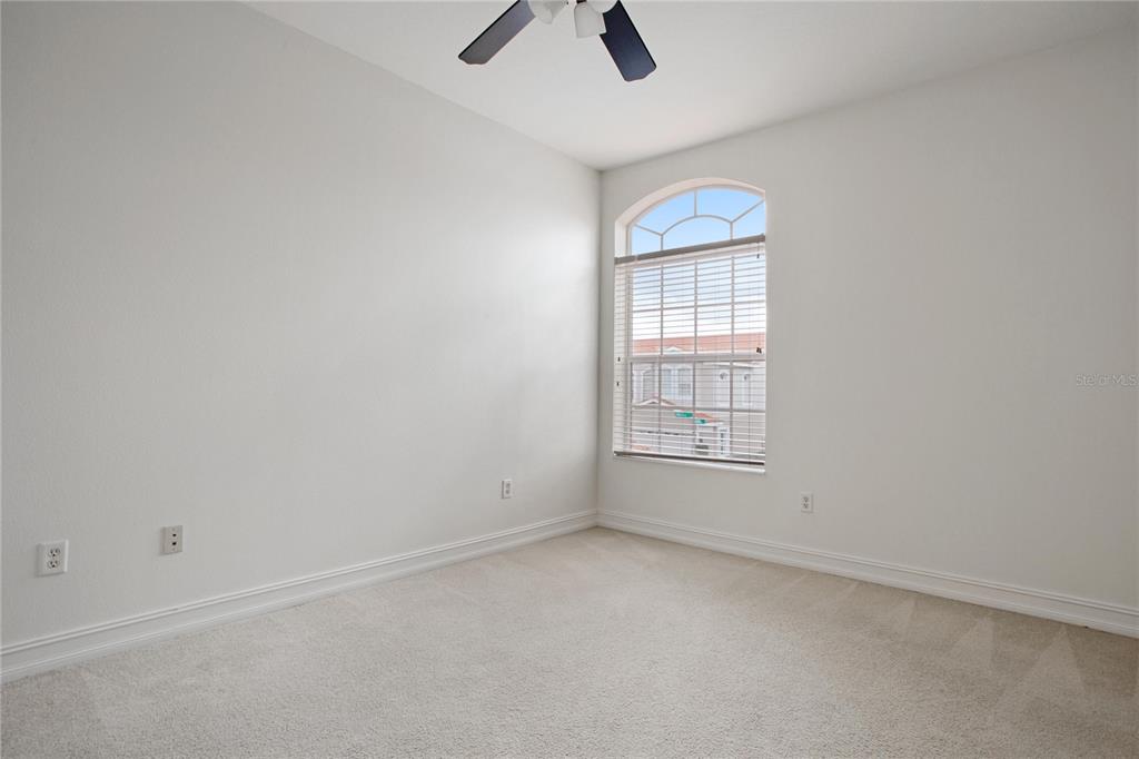1344 Ribolla Drive Palm Harbor, FL 34683 - Photo 21 of 26 an empty room with ceiling fan and window