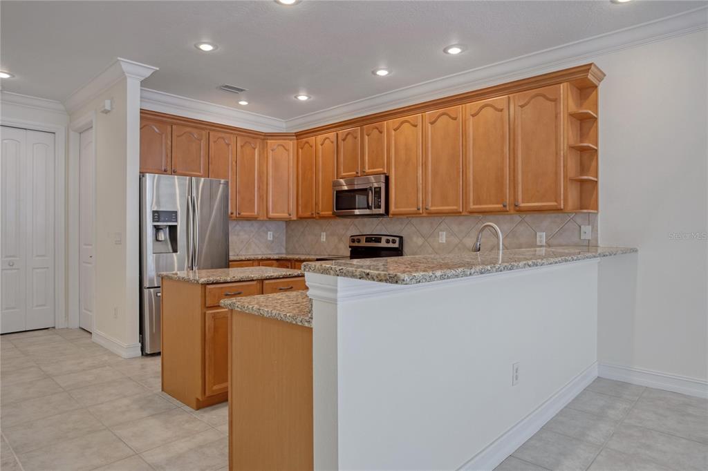 1344 Ribolla Drive Palm Harbor, FL 34683 - Photo 6 of 26 a kitchen with a refrigerator sink and cabinets