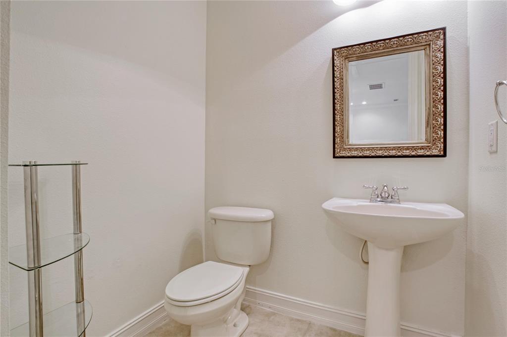 1344 Ribolla Drive Palm Harbor, FL 34683 - Photo 7 of 26 a bathroom with a toilet sink and mirror