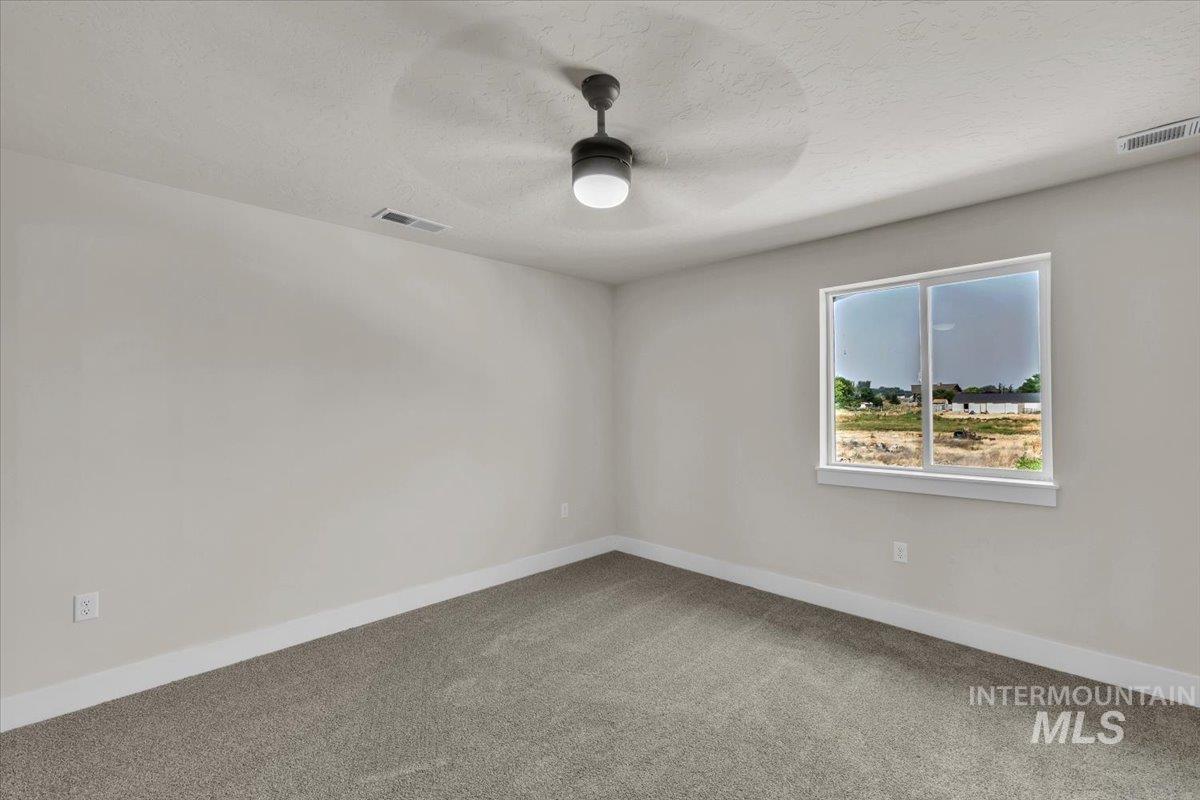 72 South Ravine Way Nampa, ID 83687 - Photo 29 of 48 Spacious room with light gray walls, plush gray carpet, and white trim throughout