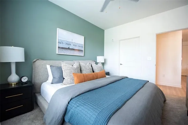 a bed room with a bed and a night stand