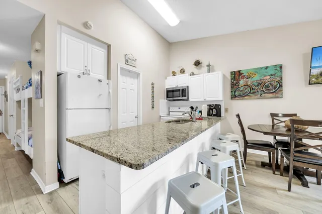 a dining room with furniture and a view of kitchen
