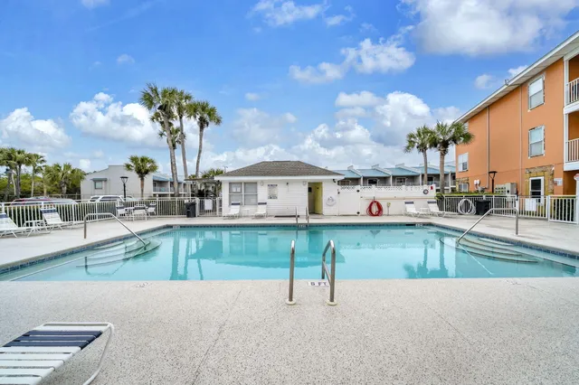 a view of a house with swimming pool and sitting area