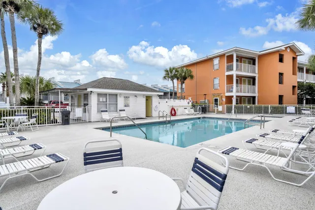 a view of a lake with lawn chairs