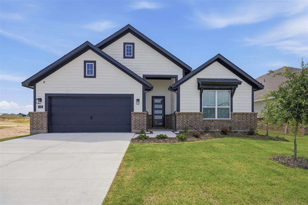1325 Frio Drive Springtown, TX 76082 - Photo 2 of 24 Contemporary home with a gabled roofline, dark-framed windows, brick accents, and a two-car garage