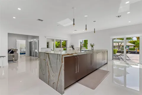 a view of a dining room with furniture a livingroom and chandelier