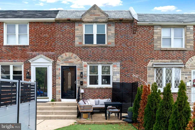 a front view of a house with outdoor seating