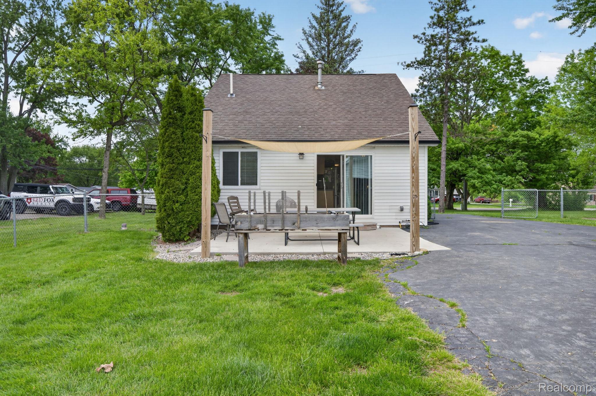 6354 Lapeer Road Burton, MI 48509 - Photo 31 of 44 Rear view of property with roof with shingles and a patio