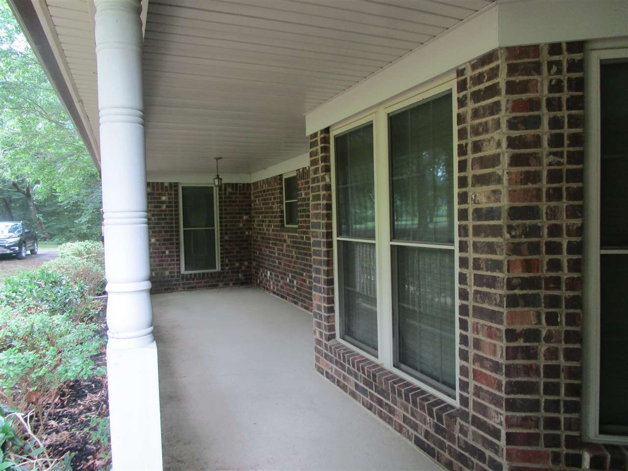 Large inviting entry to home.  A great place to hang a porch swing and relax