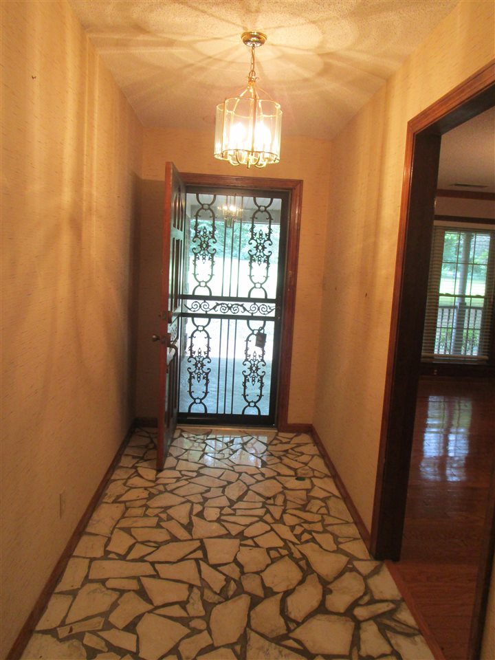 Iron security door and broken marble flooring