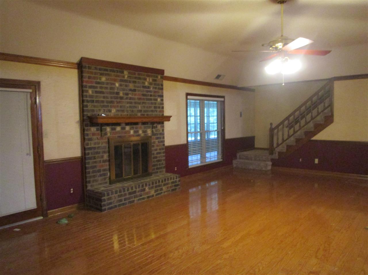 9711 Monasco Road Millington, TN 38053 - Photo 19 of 19 Massive room (27x20)with hardwood floors and Gas Log fireplace Open floor plan to Kitchen Great flow and Super for entertaining Staircase leads to unfinished attic for development in the future or just tons of storage.
