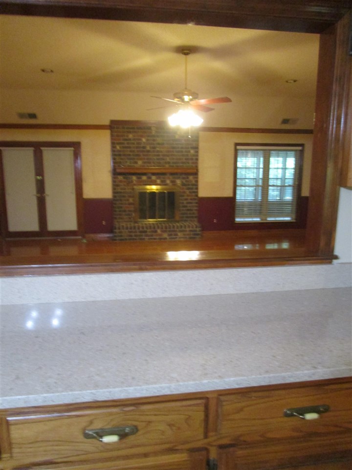 View from kitchen to great room Stone countertops everywhere