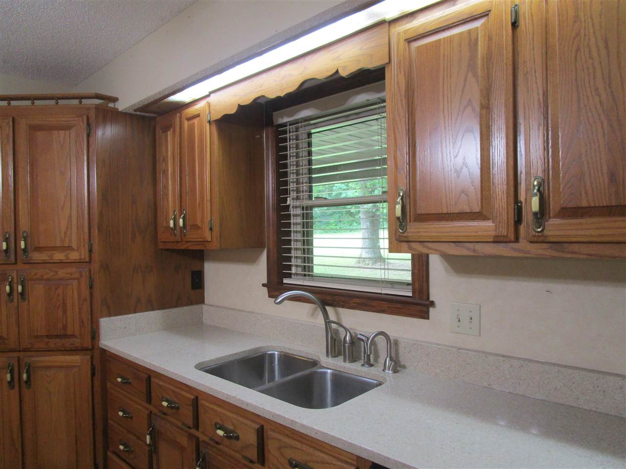 Look out from sink to quiet and secluded front yard.