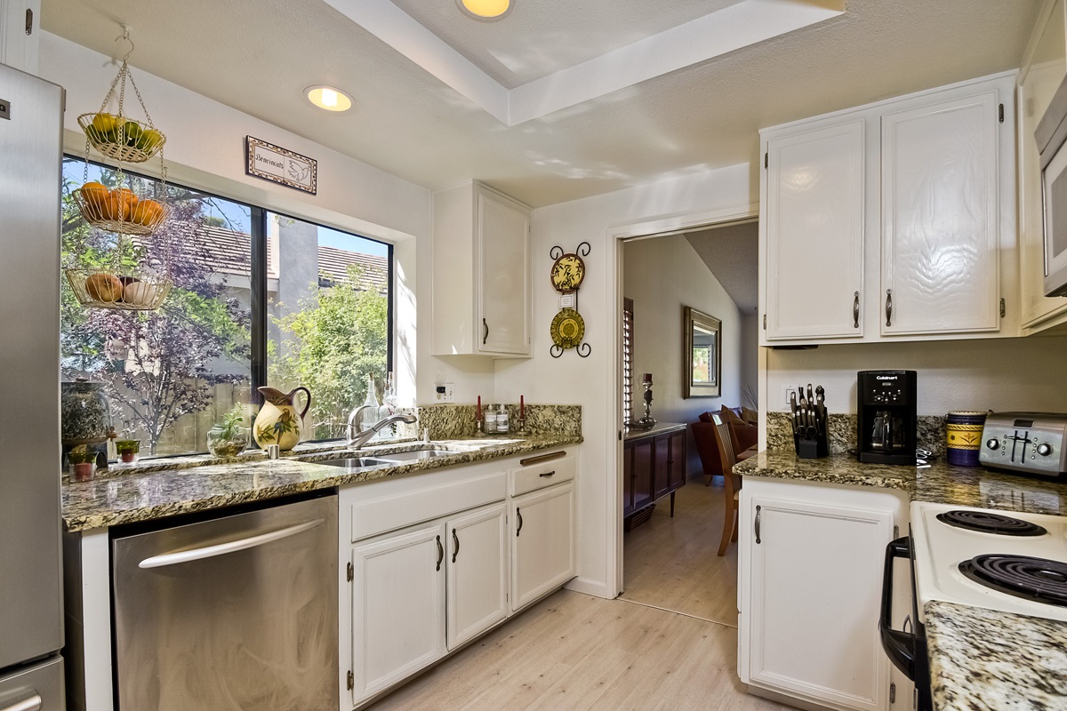 745 Winding Way Encinitas, CA 92024 - Photo 10 of 25 Sun drenched kitchen with granite counters, plenty of storage and easy access to all of your guests as you entertain~