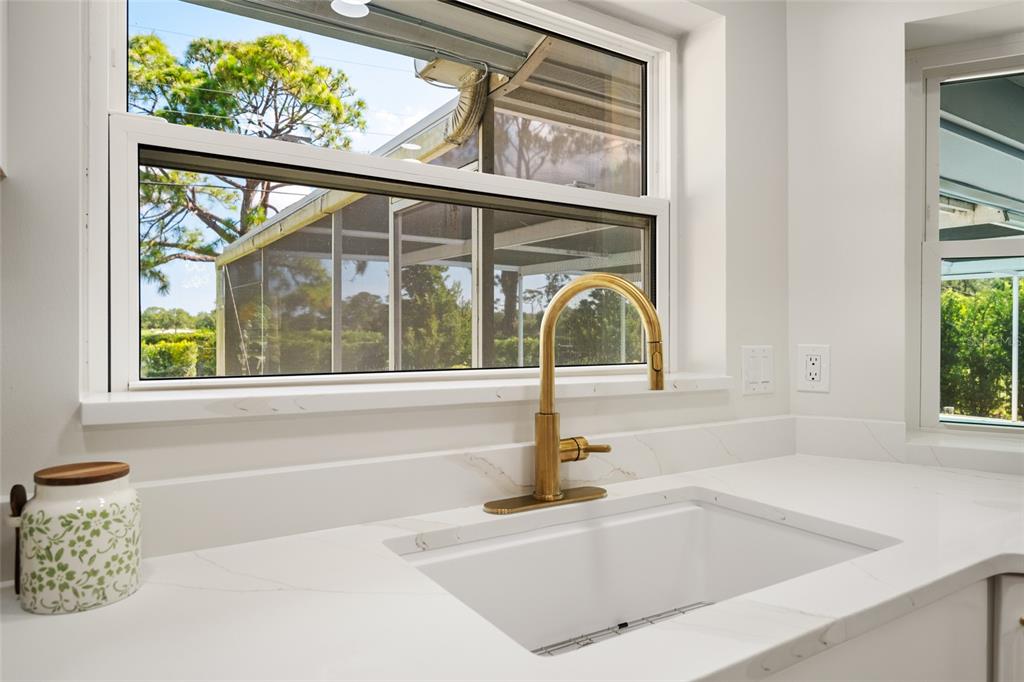 656 Mehlenbacher Road Belleair, FL 33756 - Photo 12 of 49 a bathroom with a tub a sink and a window