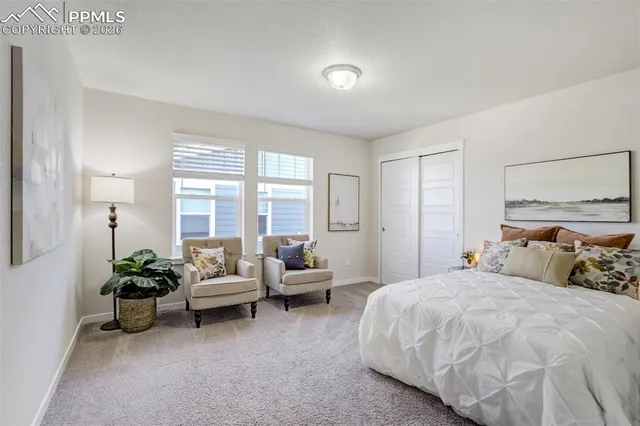 a bedroom with two beds and a window