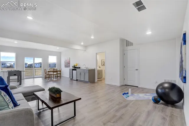 a living room with furniture and wooden floor