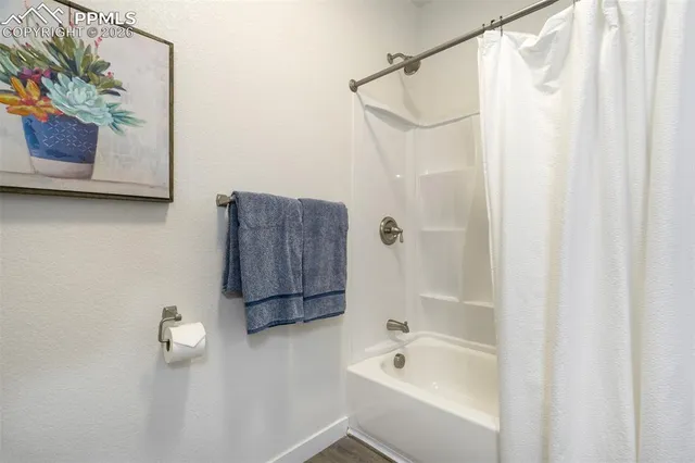 a bedroom with a bed and a painting on the wall