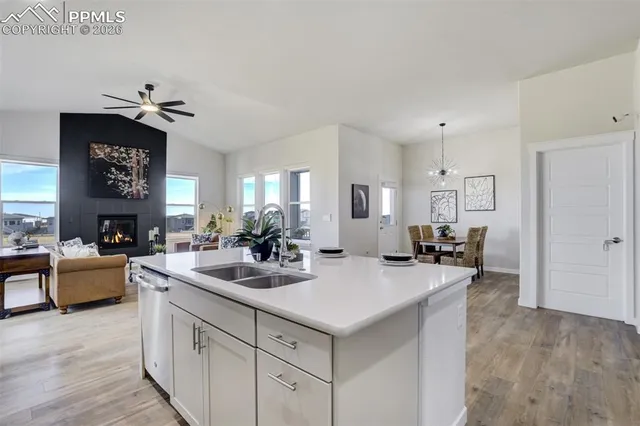 a kitchen with sink refrigerator and cabinets