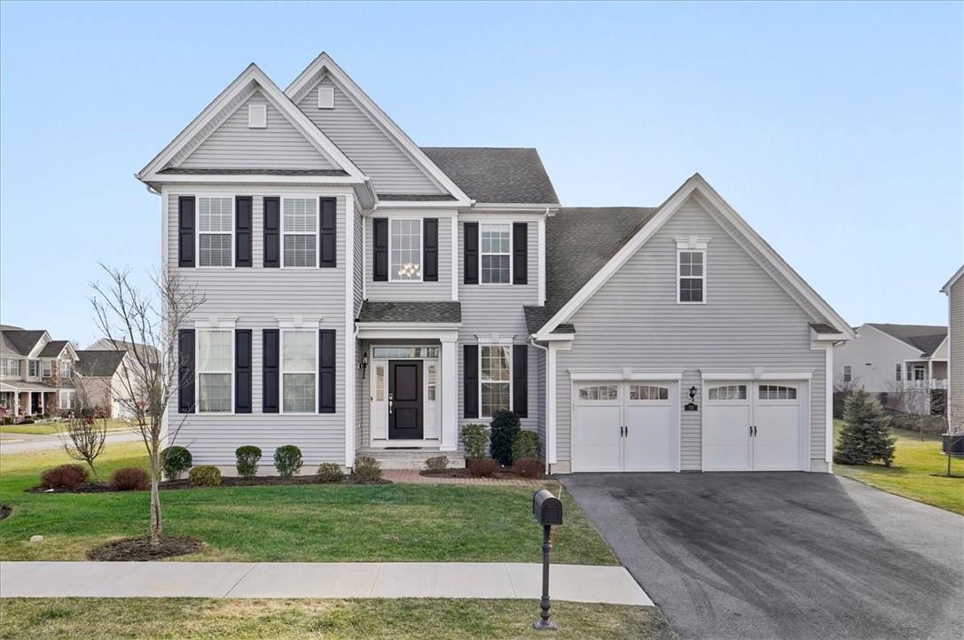 a front view of a house with a yard