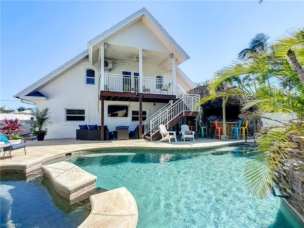 a view of a house with a yard and sitting area