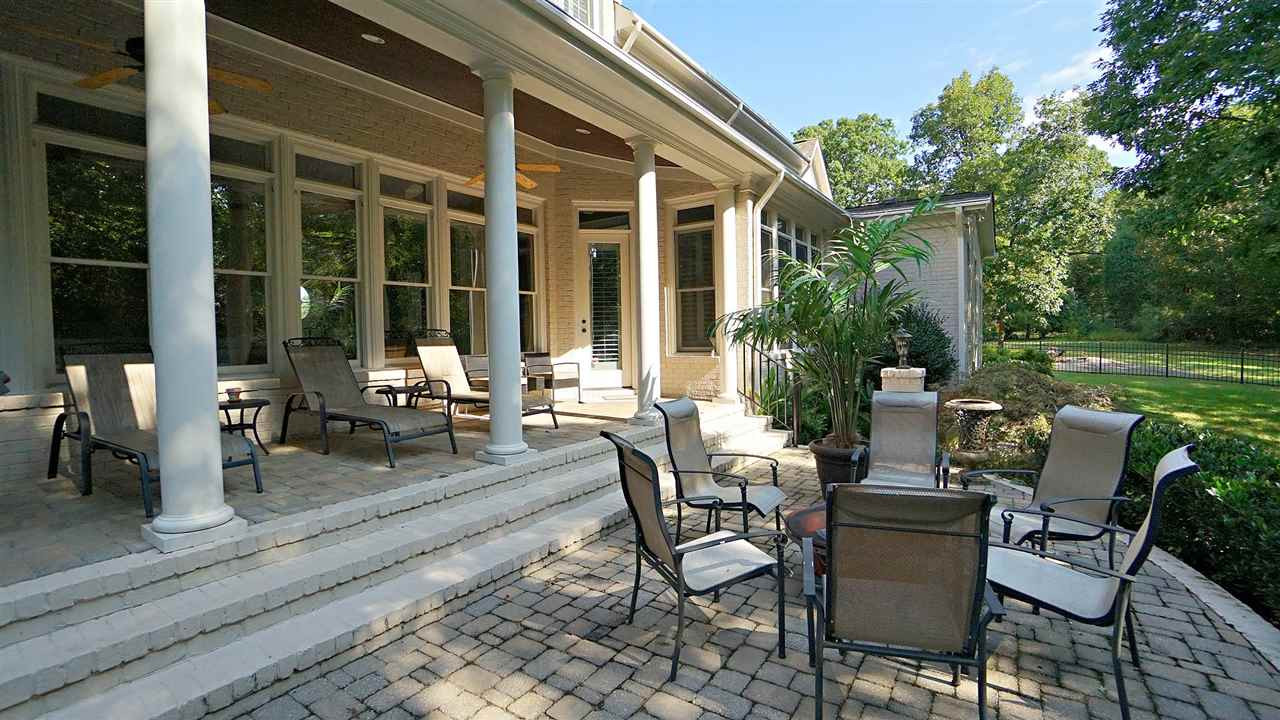 12512 Bayleaf Church Road Raleigh, NC 27614 - Photo 27 of 30 Beautiful covered porch with built in recessed lighting, ceiling fan, stained wood beadboard ceiling complements brick floor Covered Porch