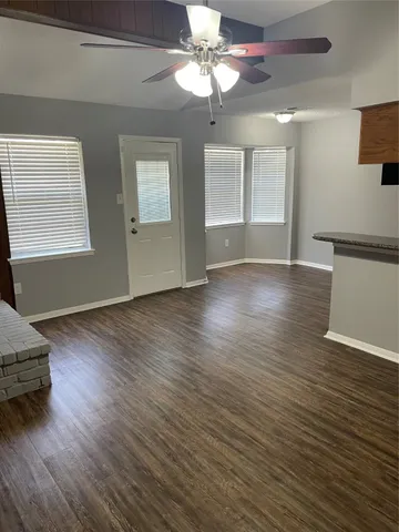 a view of a room with wooden floor and chandelier