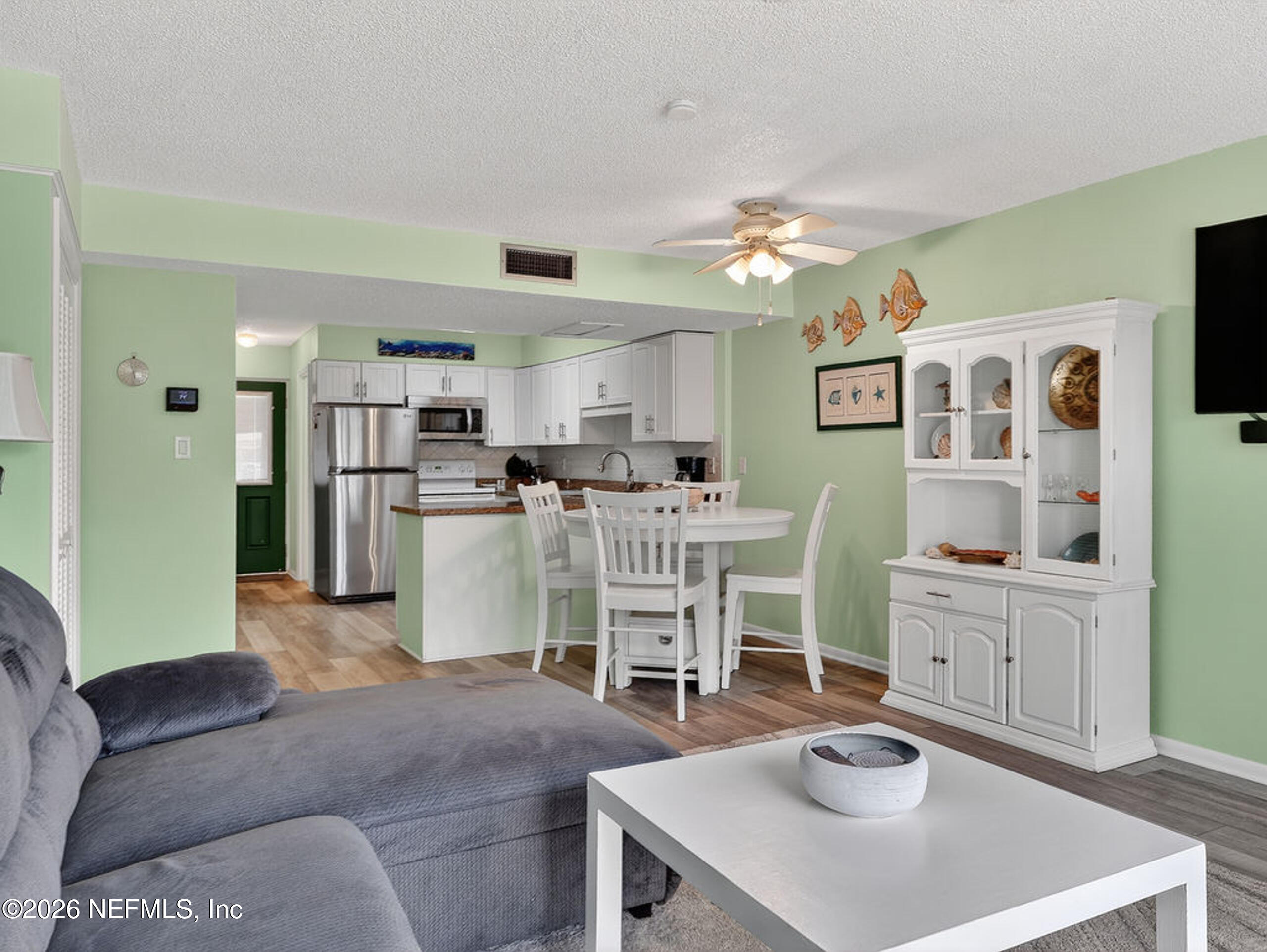 1 Ocean Trace Road, Unit 230 St. Augustine Beach, FL 32080 - Photo 15 of 50 a living room with furniture and a kitchen