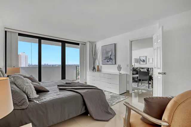 a bedroom with furniture and a large window